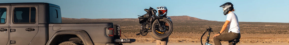 Jasion folding electric bike being unloaded from Jeep truck in desert landscape, portable ebike for outdoor adventure