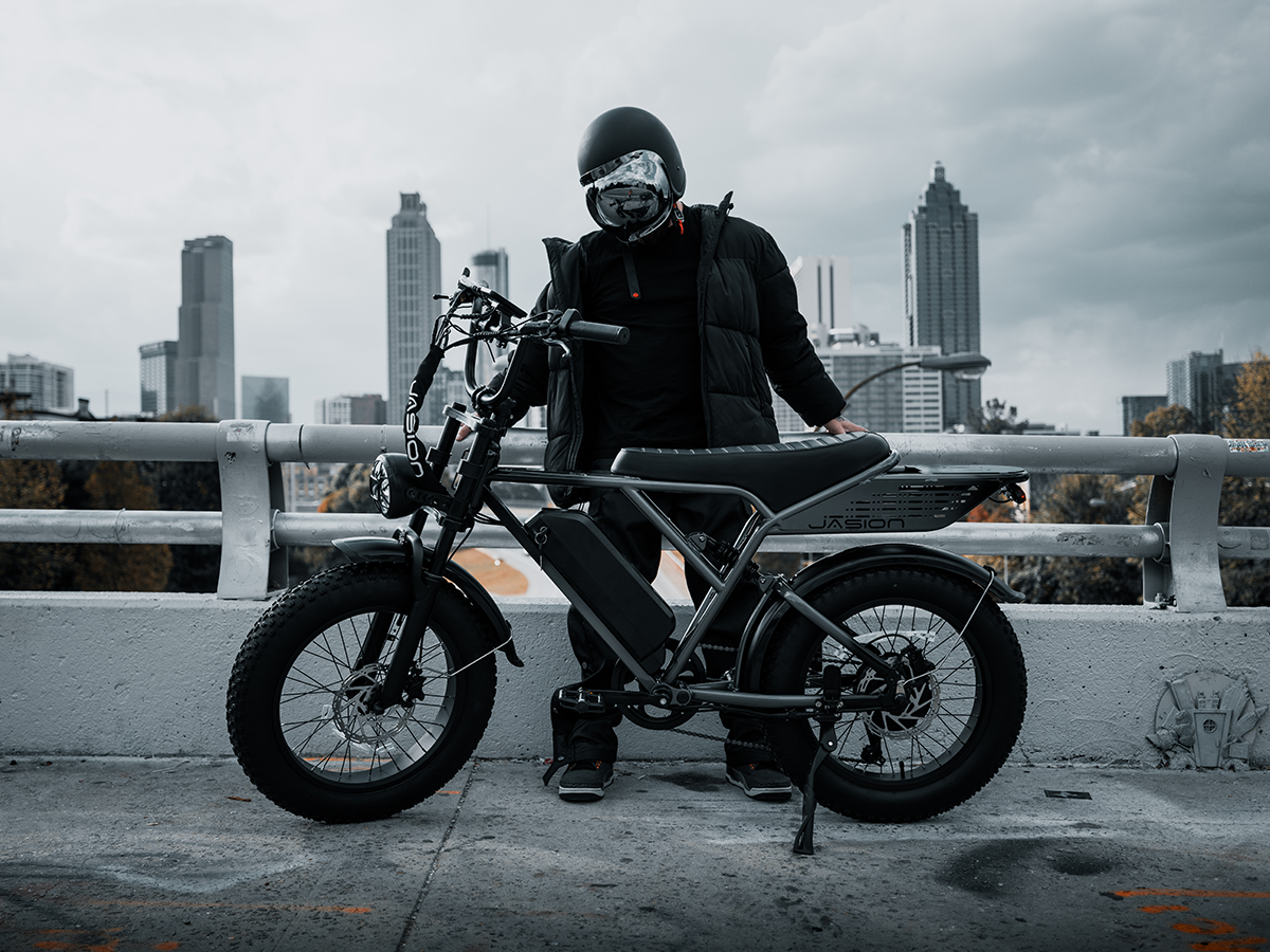 Rider standing with JasionBike RetroVolt Pro electric bike in an urban scene